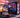 High-performance gaming PC setup with RGB lighting and dual monitors showcasing vibrant game graphics.