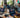 Diverse creators working with powerful gaming laptops in a modern workspace, highlighting technology's impact on creativity